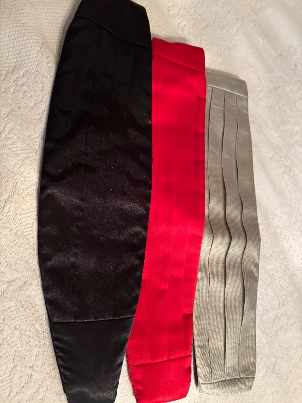3 Unbranded Cummberbunds (Black, Grey, & Silver). Each is adjustable.